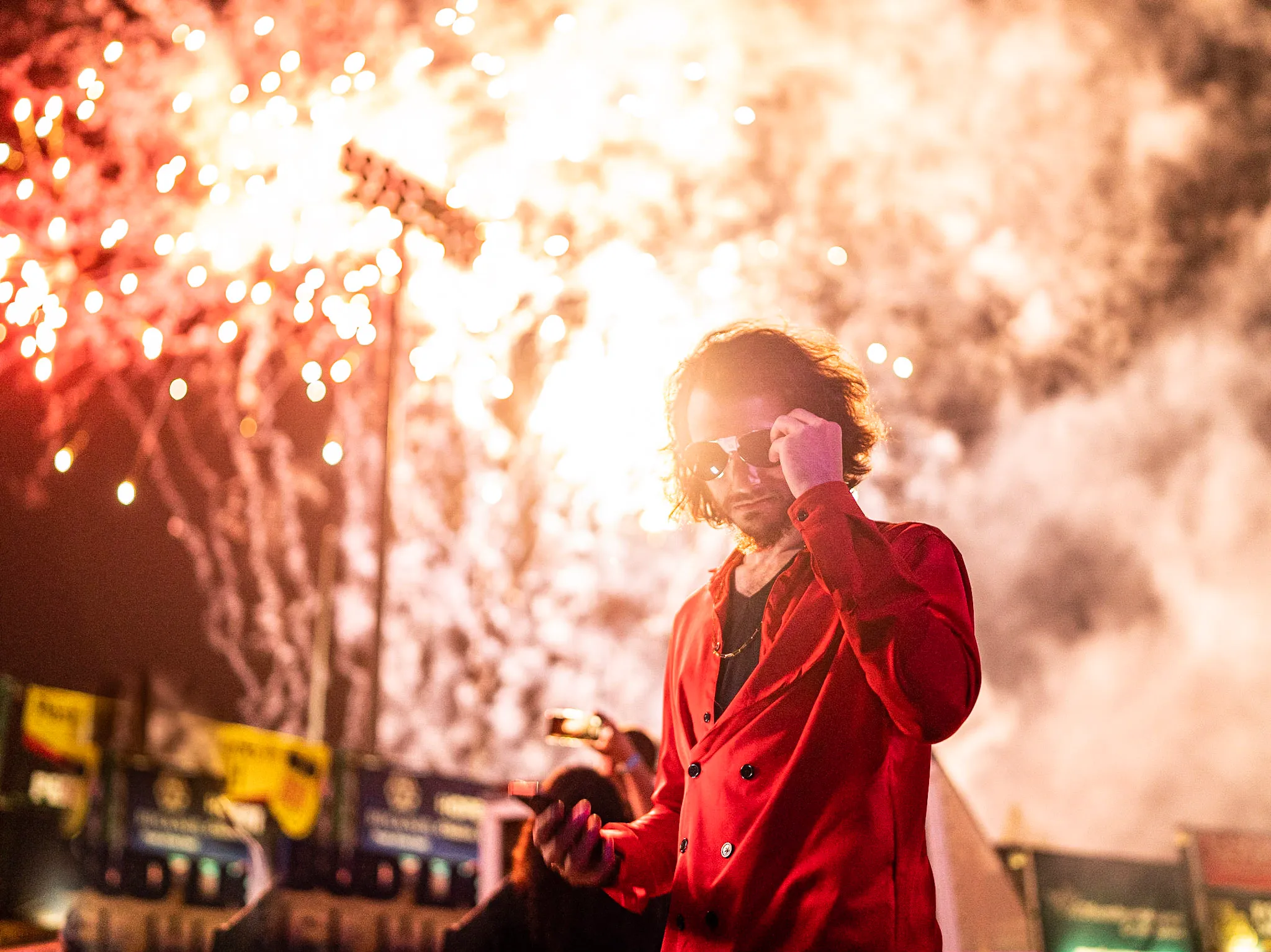 Rito Rhymes standing in front of fireworks