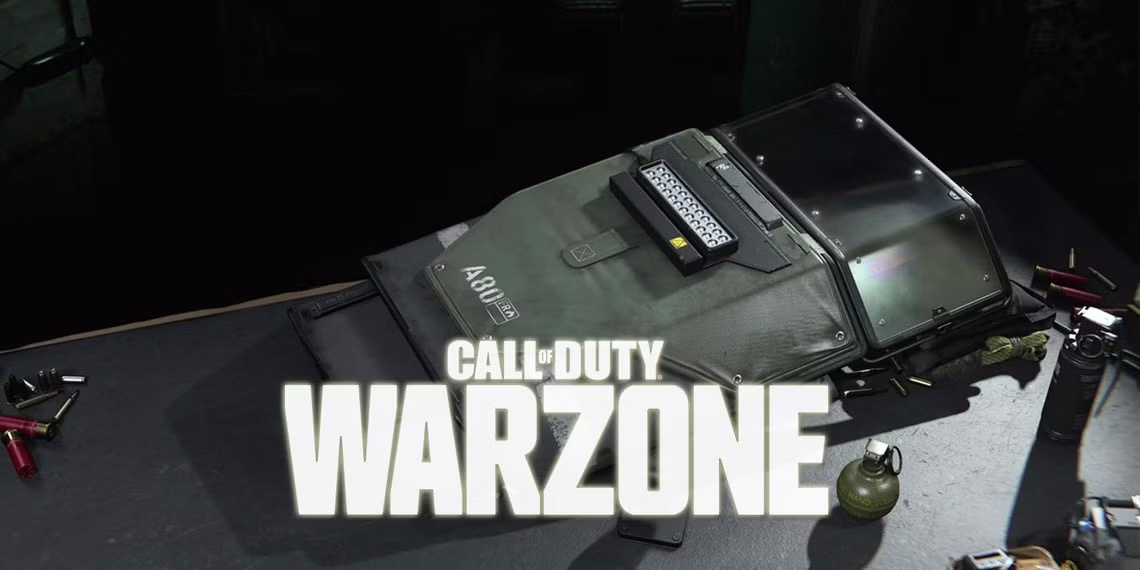 A grey riot shield laying down with the caption over it "Call of Duty Warzone"